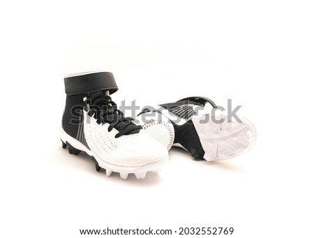 A pair of baseball cleats, baseball shoes for kids isolated on white background.