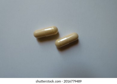 Pair Of Beige Capsules Of Milk Thistle Extract