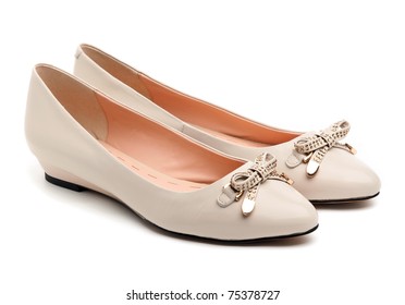 Pair of beige female shoes over white background