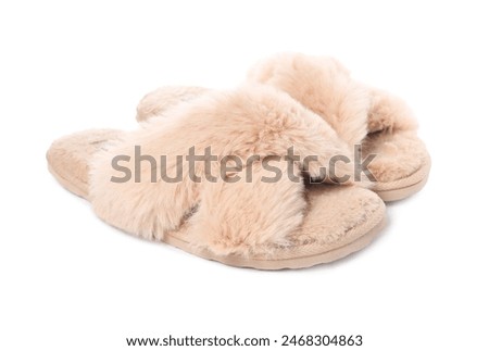 Pair of beige soft slippers isolated on white