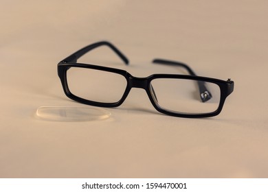 Pair Of Black Broken Reading Glasses