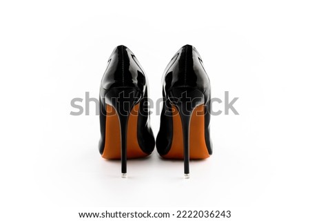 a pair of black classic women's high-heeled shoes on white background