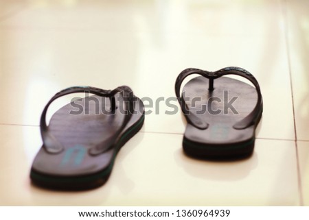 a pair of black flip-flops on the floor