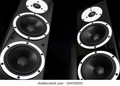 Pair Of Black High Gloss Music Speakers Isolated On Black Background