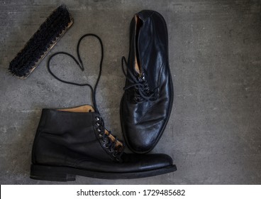 Pair Of Black Leather Retro Shoes And Wooden Shoe Brush On Grey Background With Copy Space. 
