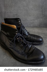 Pair Of Black Leather Retro Shoes And Wooden Shoe Brush On Grey Background With Copy Space. 
