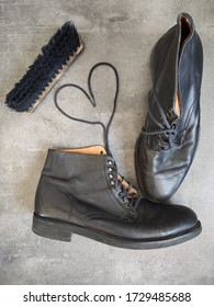 Pair Of Black Leather Retro Shoes And Wooden Shoe Brush On Grey Background With Copy Space. 
