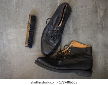 Pair Of Black Leather Retro Shoes And Wooden Shoe Brush On Grey Background With Copy Space. 
