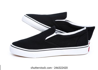 Pair Of Black Sneakers On White