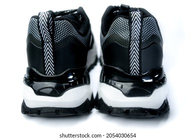 Pair Of Black And White Sneaker Shoes On White Background Seen From Behind In Bright Light, Contrasting Colours Chunky Running Sneakers