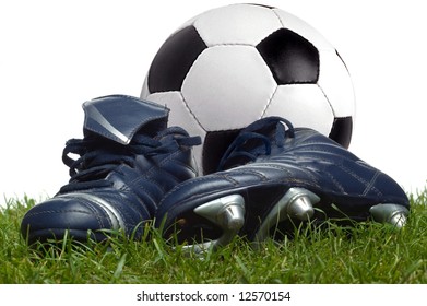 A Pair Of Boots And A Football On The Grass, Studio Shot.