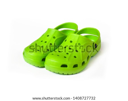 Pair of bright green clogs isolated on white background