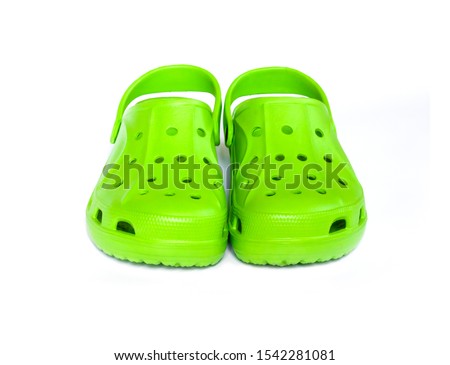 Pair of bright green clogs isolated on white background. Front view