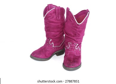 Pair of bright pink cowgirl boots on white background.
