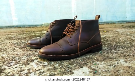 A pair of Brown chukka boots side view taken in the morning with natural light
