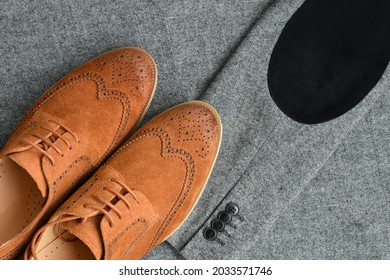 A Pair Of Brown Suede Derby Shoes On Tweed Blazer Background. Top View.