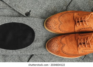 A Pair Of Brown Suede Derby Shoes On Tweed Blazer Background. Top View.