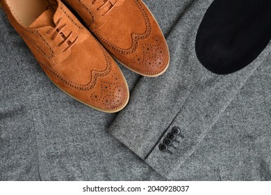 A Pair Of Brown Suede Derby Shoes On Tweed Blazer Background. Top View.