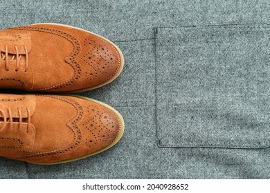 A Pair Of Brown Suede Derby Shoes On Tweed Blazer Background. Top View.