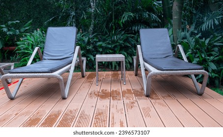 pair of chaise lounge chairs in the swimming pool at luxury hotel - Powered by Shutterstock