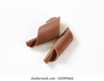 pair of chocolate shavings on white background