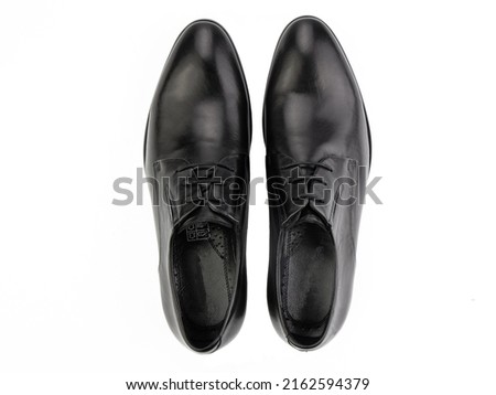 A pair of classic leather elegant men's shoes isolated white background. Groom's stylish black shoes. Isolated object close up on white background. Top view
