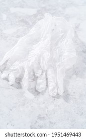 Pair Of Clear Disposable White Vinyl Gloves On The Counter.