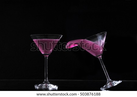 pair of cocktail glasses with colored water / glasses of colored water
