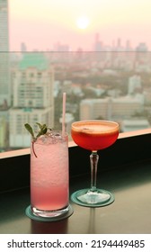 Pair Of Cocktails On The Rooftop Bar Counter At Sunset