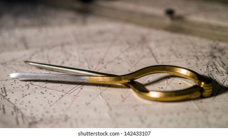 Pair Of Compasses Used For Navigation On A Sea Map With Low Depth Of Field