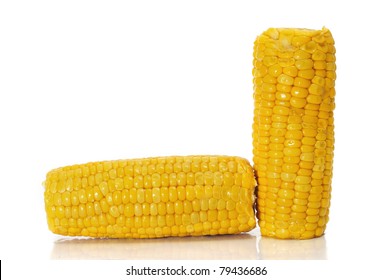 a pair of cooked corncobs on a white background