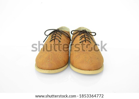 A pair of cute brown oxford shoes for woman in the front side with white background