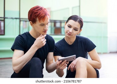 Pair Of Dancers Watching Video Lesson Of Dancing On The Phone. Online Learning To Dance, Practicing From Videos