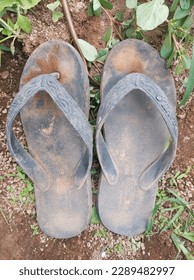 A pair of dirty black sandals