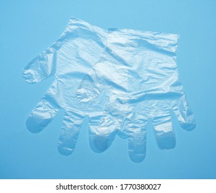 Pair Of Disposable Polyethylene Gloves On A Blue Background, Top View, Flat Lay