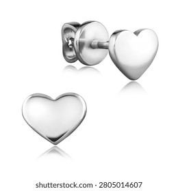 A pair of elegant sterling silver stud earrings in a sleek heart shape with a polished finish. The romantic jewelry is isolated on a white background with a soft reflection.                               