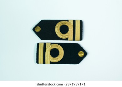 A pair of epaulette gold bar second officers, reverse, isolated on white