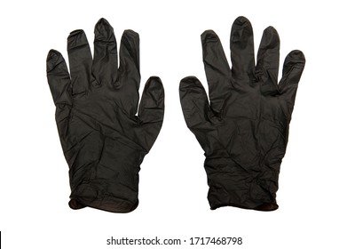 Pair of examination and protective black nitryle disposable gloves used in the COVID-19 global pandemic as a personal protection against coronavirus SARS-CoV-2 attack