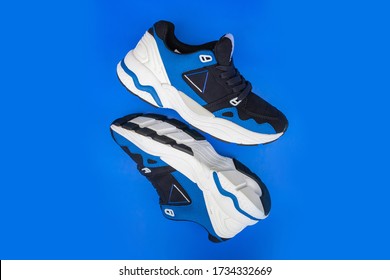 Pair of fashion colorful sneaker shoe on a blue isolated backgroundFitness sneakers shoes for training, running shoe. Sport shoes.Fashion black sneaker, daddy shoe, ugly shoe, street fashion.