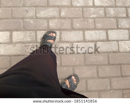 a pair of feet on the floor in a square pattern