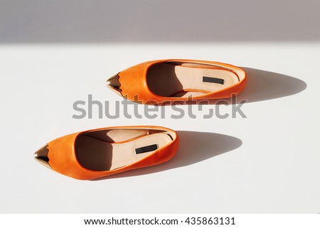 Pair of female summer shoe on white background.orange girls shoes without heels