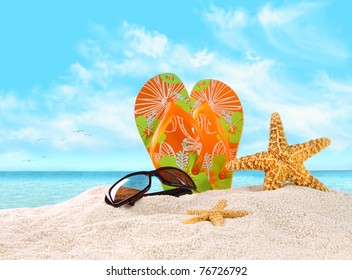 Pair of flip- flops in the sand with starfish - Powered by Shutterstock