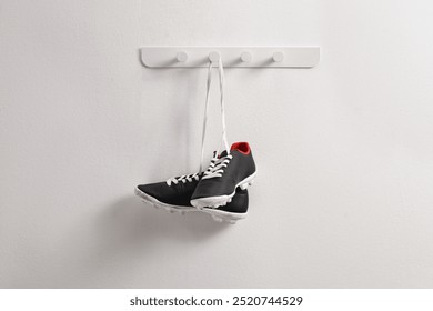 Pair of football cleats hanging on a wall - Powered by Shutterstock