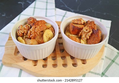 Pair of Fresh Baked Delectable Banana Bread Pudding in Ceramic Bowls on Wooden Breadboard