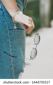 A Pair of Glasses being Held