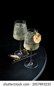 A Pair Of Goblets With Gin Cocktails In A Dark Empty Bar, Side View