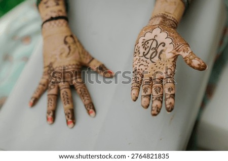 Pair of gracefully adorned hands showcasing intricate henna patterns, highlighting cultural artistry and traditional beauty, perfect for wedding themes