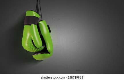 Pair Of Green Boxing Gloves Hanging On All