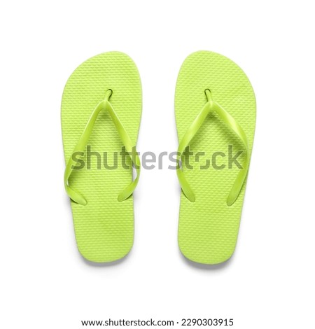 Pair of green flip-flops on white background