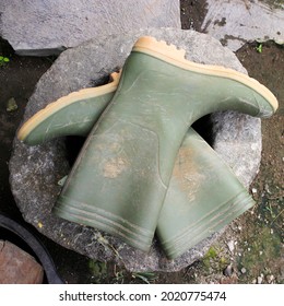 A Pair Of Green Rubber Boots With Gum Sole.